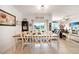 Bright dining area with a farmhouse table and access to the living room at 27441 Natal Dr, Punta Gorda, FL 33983