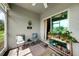 Screened porch with seating, plants, and garden views at 27441 Natal Dr, Punta Gorda, FL 33983