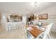Open concept kitchen and dining area with modern appliances and farmhouse table at 27441 Natal Dr, Punta Gorda, FL 33983