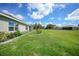 Large backyard with green grass and landscaping at 27441 Natal Dr, Punta Gorda, FL 33983