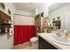 Clean bathroom with a red shower curtain and modern vanity at 27441 Natal Dr, Punta Gorda, FL 33983