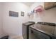 Laundry room with washer, dryer, and shelving at 27441 Natal Dr, Punta Gorda, FL 33983