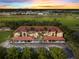 Aerial view of condo building with parking and landscaping at sunset at 7196 N Plum Tree # 313, Punta Gorda, FL 33955