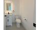 Modern bathroom featuring a vanity with black hardware and illuminated mirror above at 26345 Trinilas Dr, Punta Gorda, FL 33983