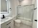 Bathroom with a modern vanity, framed mirror and glass shower doors at 26345 Trinilas Dr, Punta Gorda, FL 33983