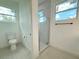 Modern bathroom with glass shower, a toilet and window at 26345 Trinilas Dr, Punta Gorda, FL 33983