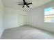Clean bedroom with a ceiling fan, closet and a window at 26345 Trinilas Dr, Punta Gorda, FL 33983