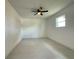 Bright, airy bedroom features modern tile flooring and ceiling fan at 26345 Trinilas Dr, Punta Gorda, FL 33983