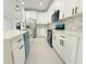 Modern kitchen with white cabinetry, stone backsplash, and stainless steel appliances, ready for cooking at 26345 Trinilas Dr, Punta Gorda, FL 33983