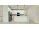 Modern kitchen featuring white cabinets, an island with pendant lighting, and stainless steel appliances at 26345 Trinilas Dr, Punta Gorda, FL 33983