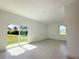 Living room with sliding glass doors offering views of the outdoors and plenty of natural light at 26345 Trinilas Dr, Punta Gorda, FL 33983