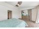 Bright bedroom with a ceiling fan, dresser, and leopard-print carpet at 1241 Macaw Ct, Punta Gorda, FL 33950