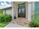 Elegant double doors entry with stone flooring at 1241 Macaw Ct, Punta Gorda, FL 33950