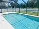 Sparkling pool with white concrete deck and screen enclosure at 2563 S San Mateo Dr, North Port, FL 34288