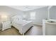 Main bedroom with white wooden bed frame at 4000 Bal Harbor Blvd # 417, Punta Gorda, FL 33950