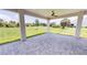 Spacious covered patio with paver flooring and ceiling fan at 28976 Gin Ln, Punta Gorda, FL 33982