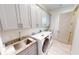 Laundry room with gray cabinets, granite countertops, and a utility sink at 28976 Gin Ln, Punta Gorda, FL 33982