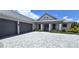 Two-story house with gray double door entry, gray double garage doors, and a paved driveway at 28976 Gin Ln, Punta Gorda, FL 33982
