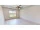 Spacious bedroom with large window and ceiling fan at 28976 Gin Ln, Punta Gorda, FL 33982