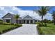 Luxury home with metal roof, paver driveway, and well-manicured landscaping at 28976 Gin Ln, Punta Gorda, FL 33982