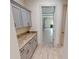 Convenient garage entry with built-in cabinets and granite countertops at 28976 Gin Ln, Punta Gorda, FL 33982