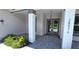 Covered front entry with double doors and gray pavers at 28976 Gin Ln, Punta Gorda, FL 33982