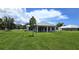 Stunning home exterior showcasing a covered patio and beautifully landscaped lawn at 28976 Gin Ln, Punta Gorda, FL 33982