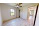 Bright bedroom with wood-look floors, a ceiling fan, and a spacious closet at 28976 Gin Ln, Punta Gorda, FL 33982
