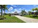 House exterior, showcasing a white two-story home with a paved driveway at 28992 Gin Ln, Punta Gorda, FL 33982