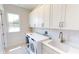 Laundry room with white cabinets and washer/dryer hookups at 28992 Gin Ln, Punta Gorda, FL 33982