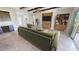 Living room with green couch, wood wall accents, and tile floors at 28992 Gin Ln, Punta Gorda, FL 33982