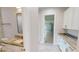Bright laundry room with white cabinets and garage access at 28992 Gin Ln, Punta Gorda, FL 33982