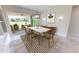 Dining room with marble table, green chairs, and access to backyard at 28992 Gin Ln, Punta Gorda, FL 33982