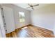 Well-lit bedroom featuring wood flooring and a ceiling fan at 28992 Gin Ln, Punta Gorda, FL 33982