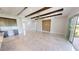 Spacious living room with high ceilings, wood beams, and tile floors at 28992 Gin Ln, Punta Gorda, FL 33982