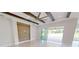 Living room with wood-look floors and sliding doors leading to a patio at 28992 Gin Ln, Punta Gorda, FL 33982