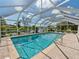 Enclosed pool area with a screened enclosure at 1191 Manor Rd, Englewood, FL 34223