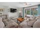 Living area with sliding doors opening to the pool at 1191 Manor Rd, Englewood, FL 34223