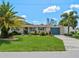 House exterior showcasing a well-maintained lawn and teal accents at 1191 Manor Rd, Englewood, FL 34223