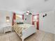 Bright bedroom with a white bed frame and tropical bedding at 1191 Manor Rd, Englewood, FL 34223