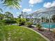 Relaxing pool area with canal view and lush landscaping at 1191 Manor Rd, Englewood, FL 34223