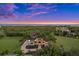 Luxury waterfront home with landscaped grounds and sunset view at 21321 Harborside Blvd, Port Charlotte, FL 33952