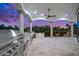 Outdoor kitchen with stainless steel appliances and sunset views at 21321 Harborside Blvd, Port Charlotte, FL 33952
