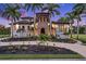 Mediterranean style home with landscaping and a paved driveway at 21321 Harborside Blvd, Port Charlotte, FL 33952