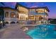 Luxury pool and spa with travertine decking and home view at 21321 Harborside Blvd, Port Charlotte, FL 33952