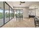 Open-concept dining area featuring large sliding glass doors leading to a patio with stunning views of lush greenery at 21321 Harborside Blvd, Port Charlotte, FL 33952