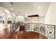 Elegant hallway with ornate railing and hardwood floors at 21321 Harborside Blvd, Port Charlotte, FL 33952