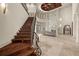 Grand foyer features a staircase with wrought iron railings, fireplace, and soaring ceilings creating an inviting atmosphere at 21321 Harborside Blvd, Port Charlotte, FL 33952