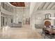Great room showcasing the grand fireplace, soaring ceilings, ornate staircase, and formal dining area at 21321 Harborside Blvd, Port Charlotte, FL 33952