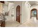 Hallway featuring tile flooring, arched entryways, decorative ceilings, and access to the staircase at 21321 Harborside Blvd, Port Charlotte, FL 33952
